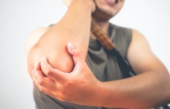 A sportsman suferring from elbow pain.