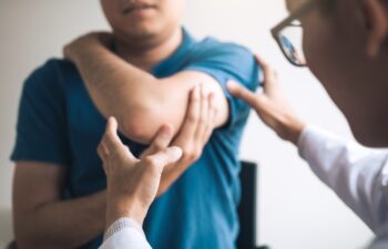 Physical therapists are checking patients elbows at the clinic office room.